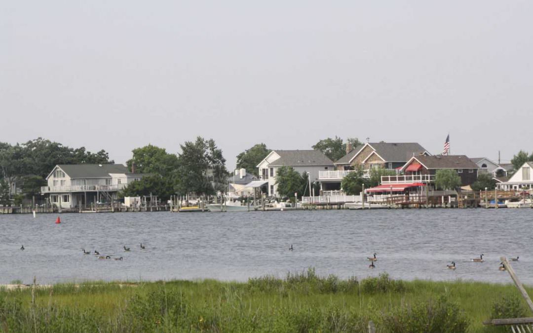 Point Lookout, with houses on the water on a sunny day