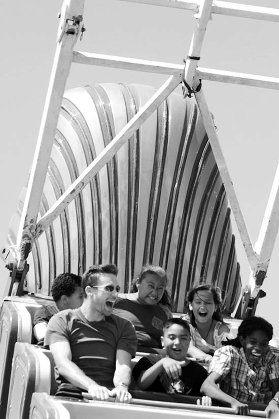 Excited riders on a rollercoaster.