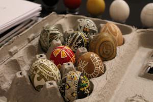 colorful pysanky in a cardboard egg container