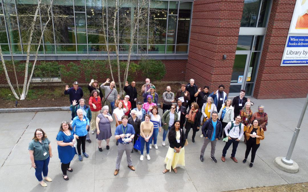 Groups photo of about 40 roundtable attendees taken from above via drone