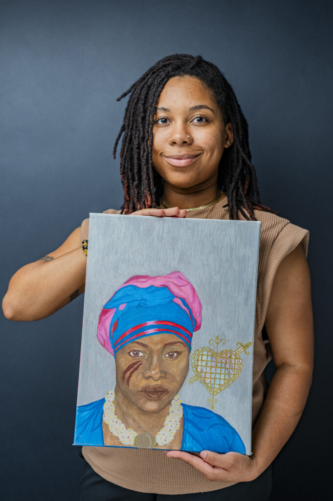 Aisha black woman, holds a portrait of of a female figure